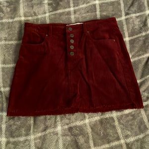 Indigo Rein Burgundy mini skirt with buttons and pockets in the front and back